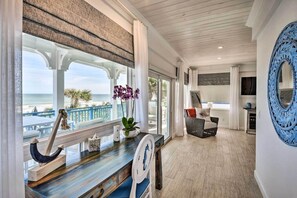 Enjoy ocean views from this room, featuring a desk, comfortable chair, and large mirror.