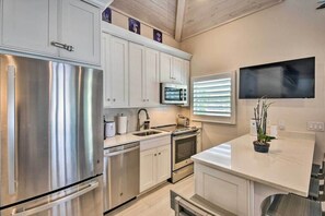Enjoy cooking in this well-equipped kitchen with a large refrigerator, oven, and microwave.
