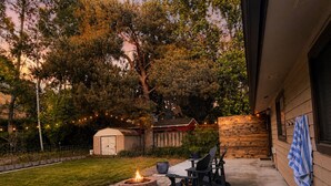 A hot tub with a fire pit, outdoor seating, and a wooden deck. - Updated Eagle Home | Hot Tub + Walk to Downtown (Eagle)