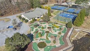 An aerial view of a golf course with multiple greens, a clubhouse, and tennis courts. - Golf & Lake View Retreat - Rumbling Bald Resort Amenities, Sleeps 6 (Lake Lure)