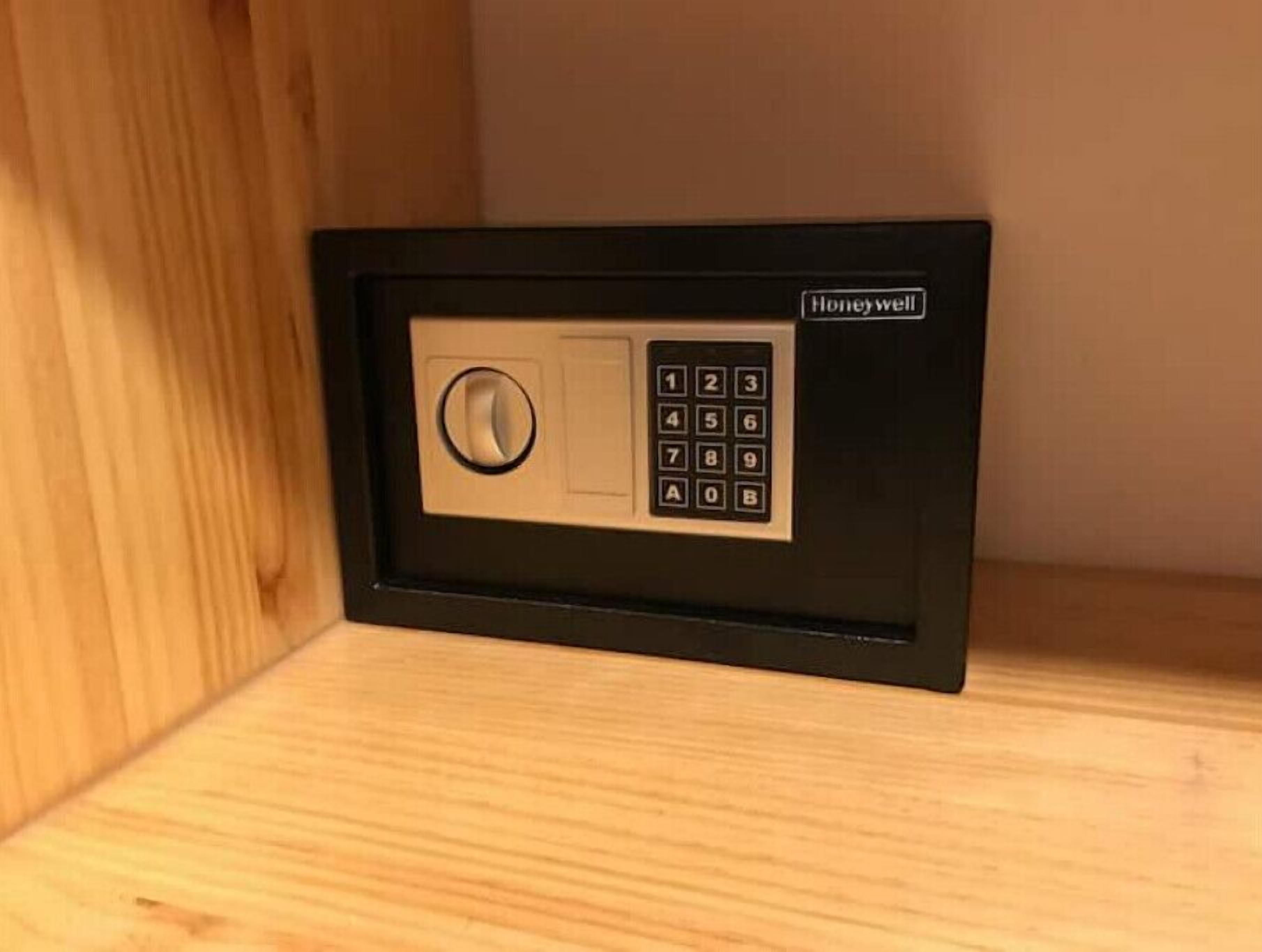 A Honeywell electronic keypad lock on a wooden surface.