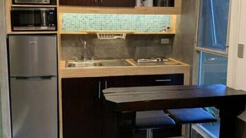 Fridge, microwave, stovetop, coffee/tea maker