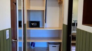 A narrow hallway with wooden shelves and a door. - ARANJUEZ LOFTS - Maya Loft #8 (Santa Ana)
