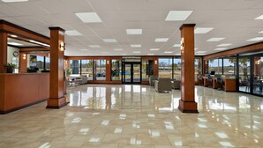A spacious lobby with a tiled floor, wooden pillars, and a reception desk. - Quality Inn Yemassee - Point South I-95 (Yemassee)