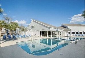 Relax by the pool surrounded by lounge chairs and umbrellas.