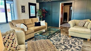 A living room with two sofas, a coffee table, a rug, and a plant.