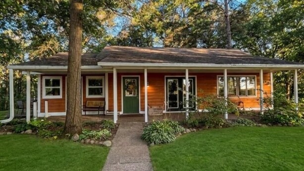A single-story house with a porch, a front door, and a small front yard.