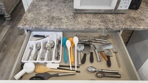 A kitchen drawer with various utensils and kitchen tools. - AV Bungalows #9A with Loft (Arcadia)