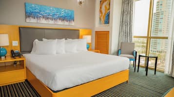 A hotel room with a large bed, bedside tables with lamps, a chair, and a view of buildings through the window.