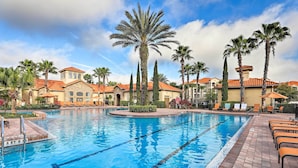 A swimming pool with clear blue water, surrounded by palm trees and lounge chairs. - 10 Mi to Disney! Family-Friendly Resort Getaway (Davenport)