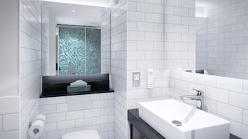 A modern bathroom with white tiles, a black countertop, a white sink, and a blue mosaic wall.