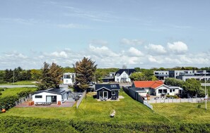 A residential area with modern houses, a grassy lawn, and a clear sky. - 2 bedroom amazing home in Esbjerg V (Esbjerg V)