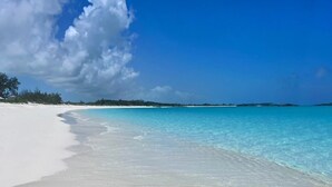 A beach with clear turquoise water and white sand. - CIESTA SANDS- Beachfront Luxury, Top Beach, 4 bedrooms w private bath, Pool (Moore Hill)