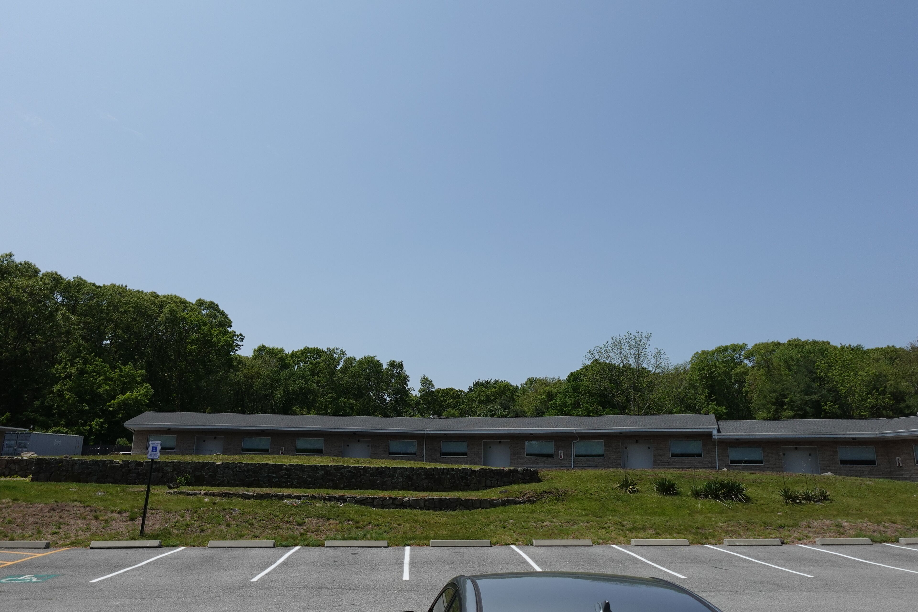 A parking lot with a building in the background.