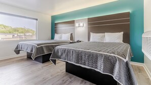 A hotel room with two beds, a view of the city, and a modern design. - Blue Beach Motel (North Kingstown)