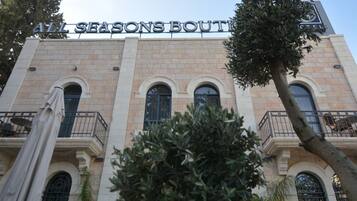 A building with the sign "ALL SEASONS BOUTIET".