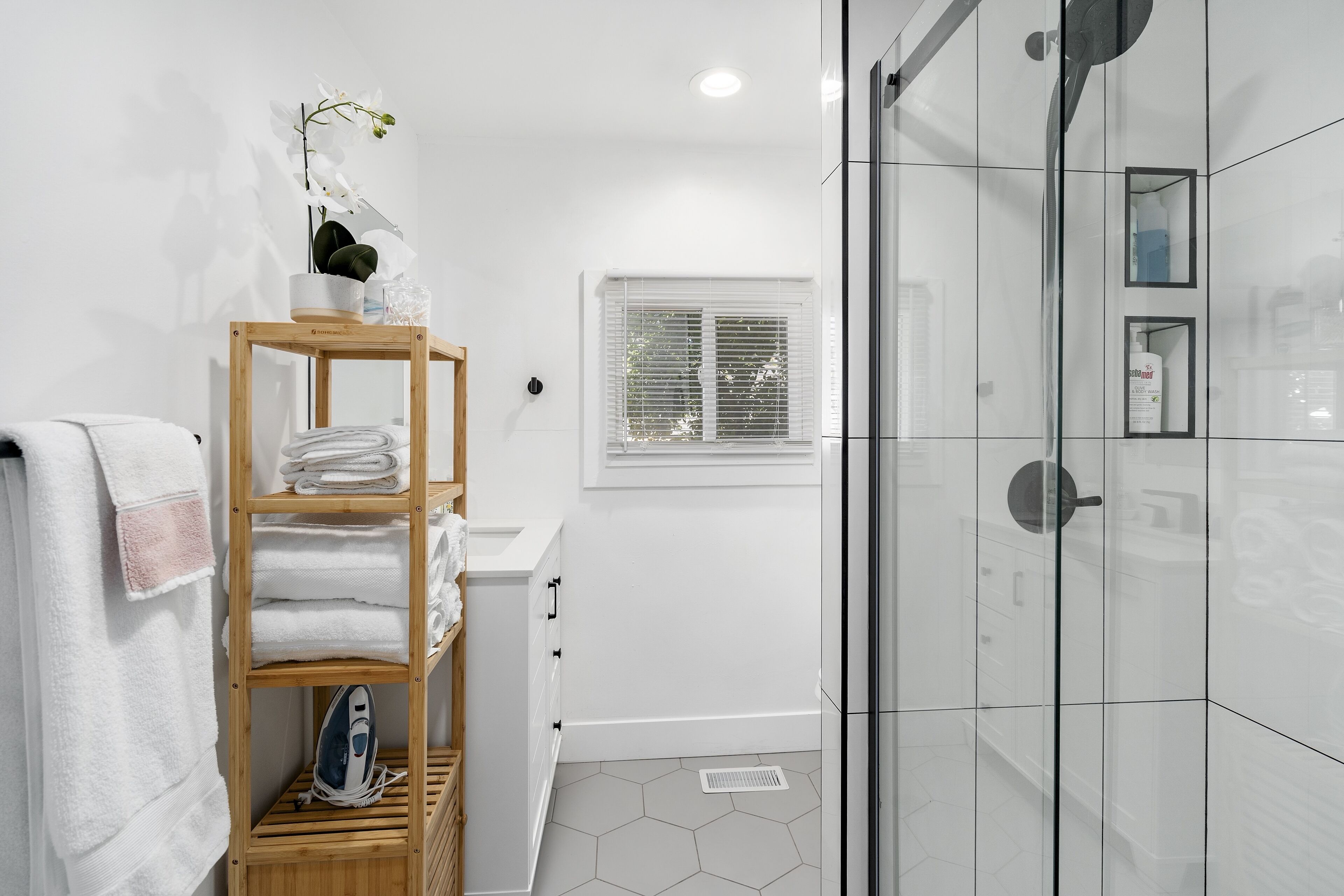 Walk-in shower - essential toiletries, towels, and hair dryer supplies provided.