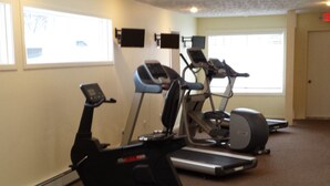 A gym with treadmills, an elliptical, and a bench. - Trout Creek Unit 8, Beautiful newly Decorated Very Clean Condo , Building 2 (Harbor Springs)