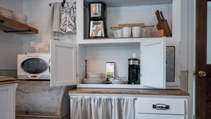 A compact kitchen with a microwave, coffee maker, and a small cabinet with drawers. - The Bigfork Riverside Retreat - No Cleaning Fee! (Bigfork)