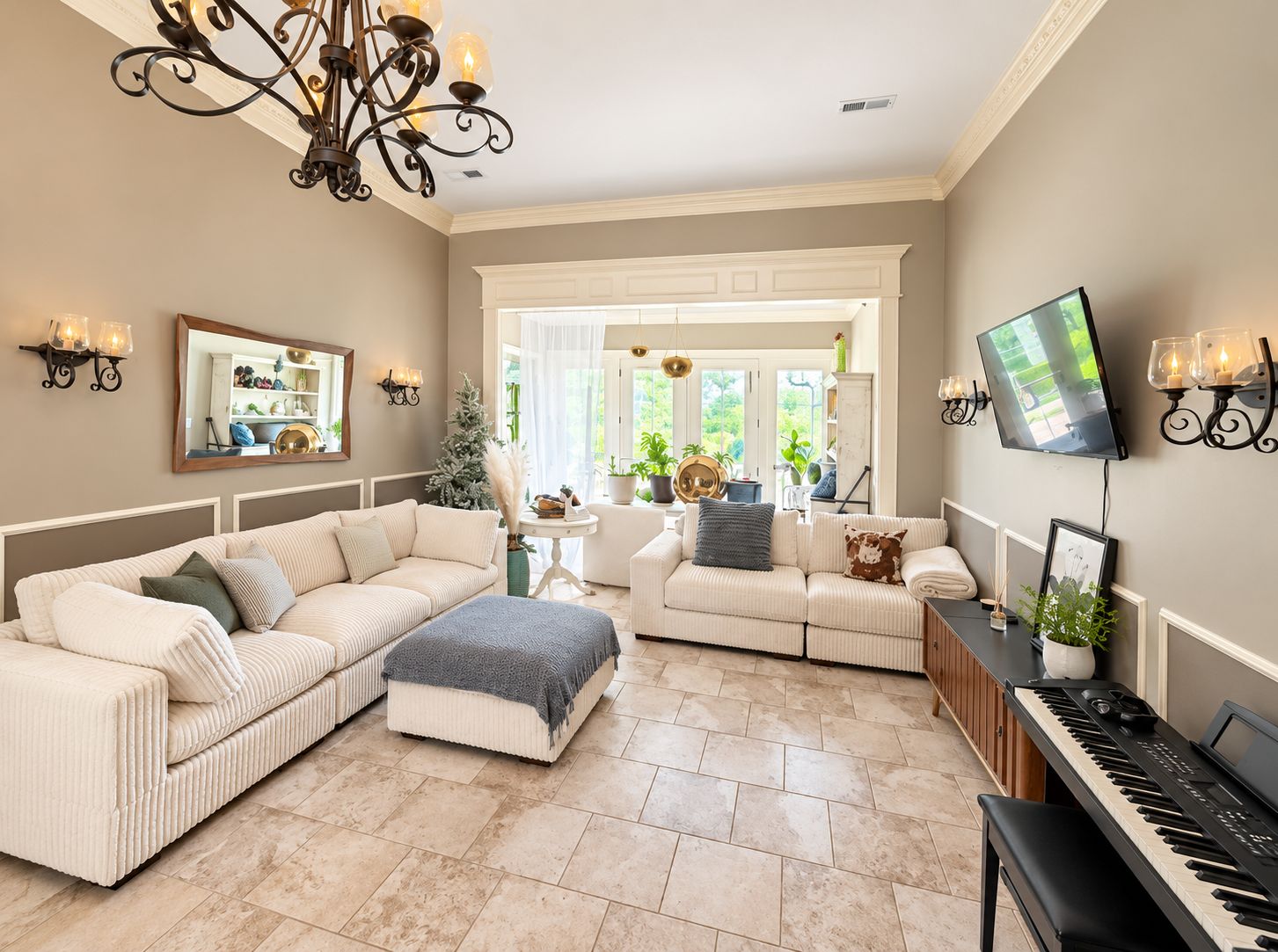 A living room with a sectional sofa, a piano, and a television.
