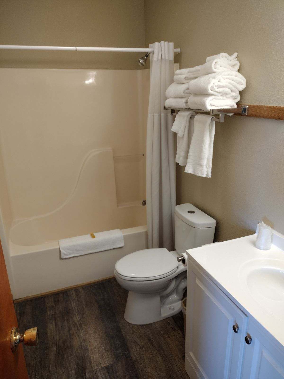 A bathroom with a bathtub, toilet, and sink.