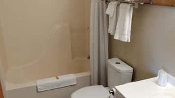 A bathroom with a bathtub, toilet, and sink.