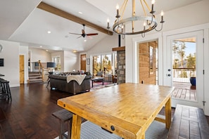 Enjoy a warm and inviting space with a large dining table, comfortable seating, and a view of the outdoors.