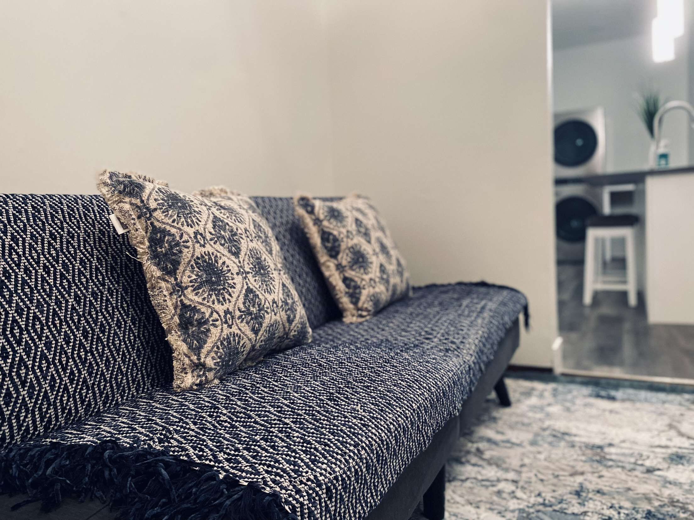 A sofa with patterned cushions in a modern living room.
