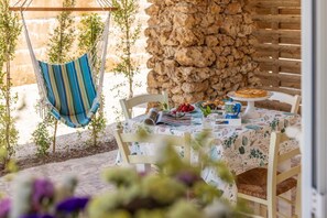 A dining table set with a book, a teapot, and a plate of food. - Cava Li Santi Residence - Monolocale 2 Int 12 (Santa Caterina)
