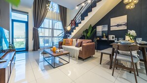 A modern living room with a sofa, coffee table, and dining area. - Instagrammable Arte Mont Kiara 2 Rooms (Kuala Lumpur)