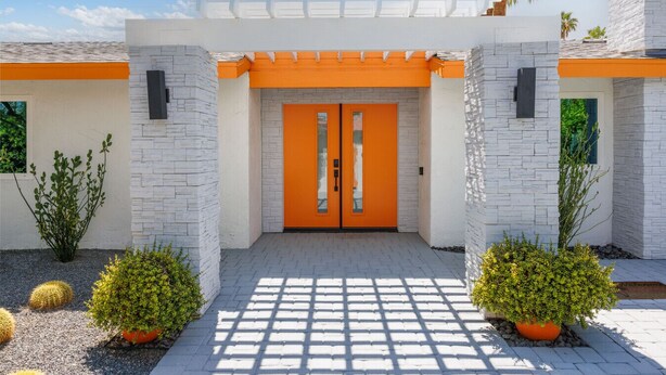 A modern house with a white and orange facade, two doors, and potted plants. - The Orchid House - Palm Springs (Palm Springs)