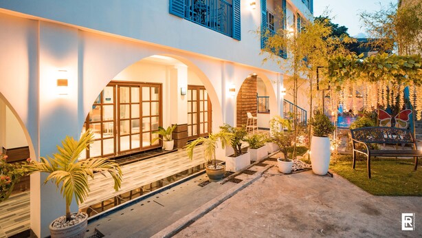 A building with multiple balconies, potted plants, and outdoor seating areas. - Bernese Resort Hotel powered by Cocotel (Ligao City)