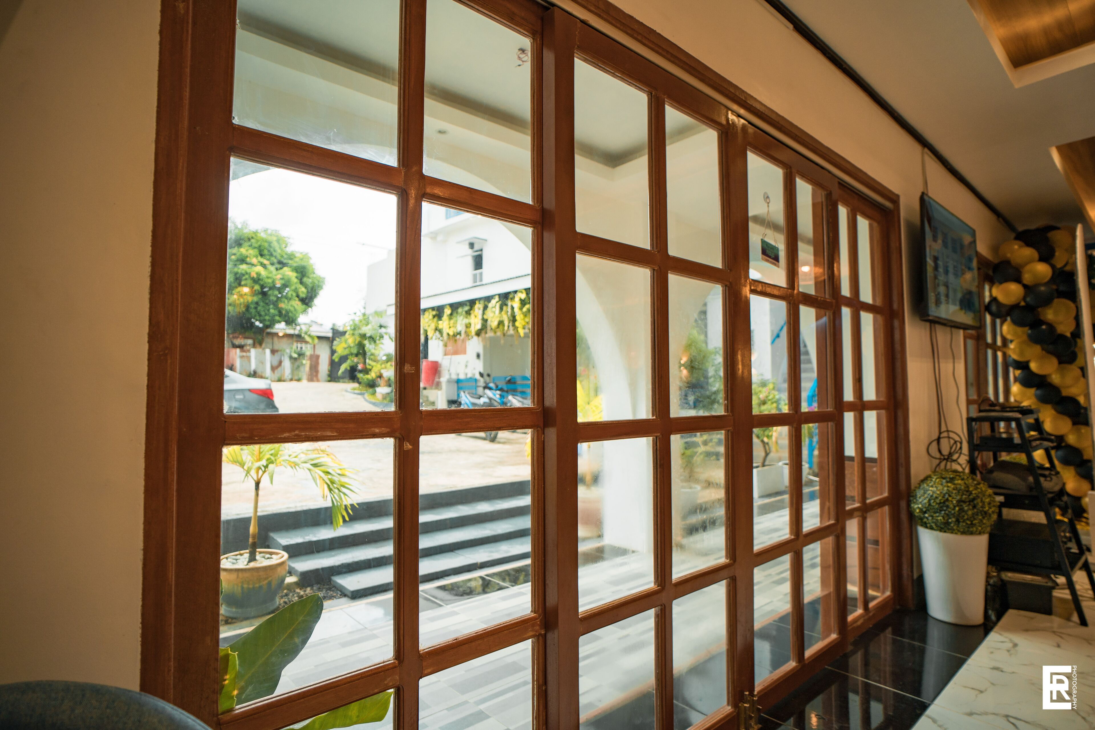 A room with a large sliding glass door leading to a balcony.