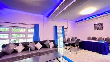 Una sala de conferencias con sofá, sillas y una mesa.