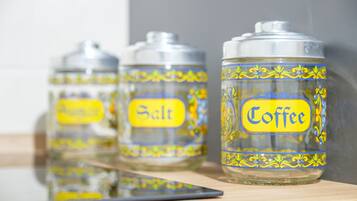 Three glass containers with labels on a reflective surface.