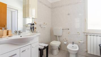 Bathtub, hair dryer, towels