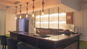 A modern hotel lobby with a reception desk, seating area, and a "No Smoking" sign. - Ariena by ABA Hotels (Morjim)