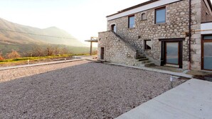 A stone building with a modern design, featuring a staircase leading to a second floor. - Tenuta San Martino - Irpinia (Nusco)