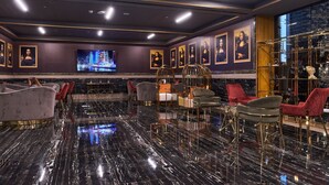 A luxurious lobby with marble flooring, elegant seating, and framed artwork on the walls. - 1BR view in a luxurious home (Dubai)