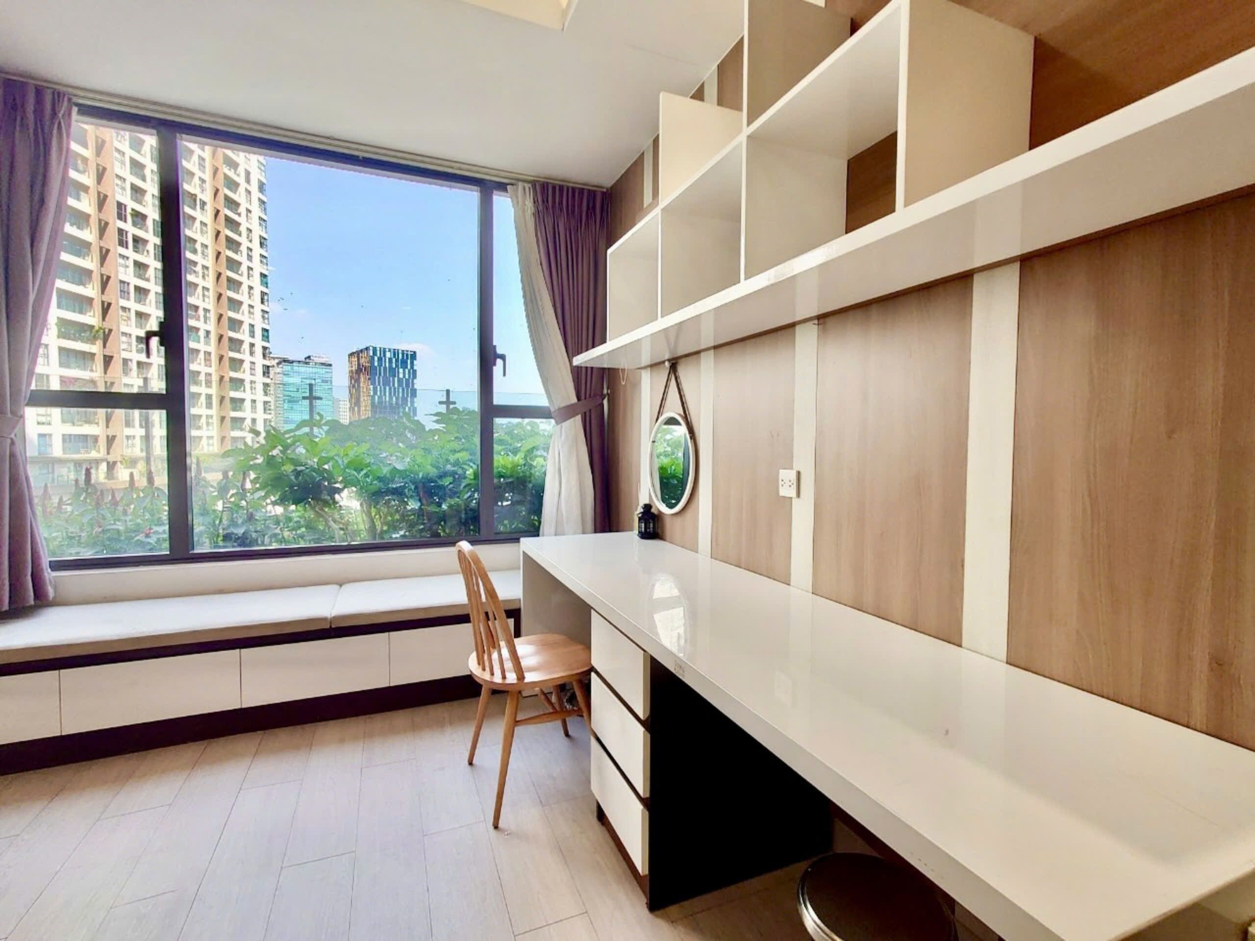 A modern room with a large window, a desk, and a chair.