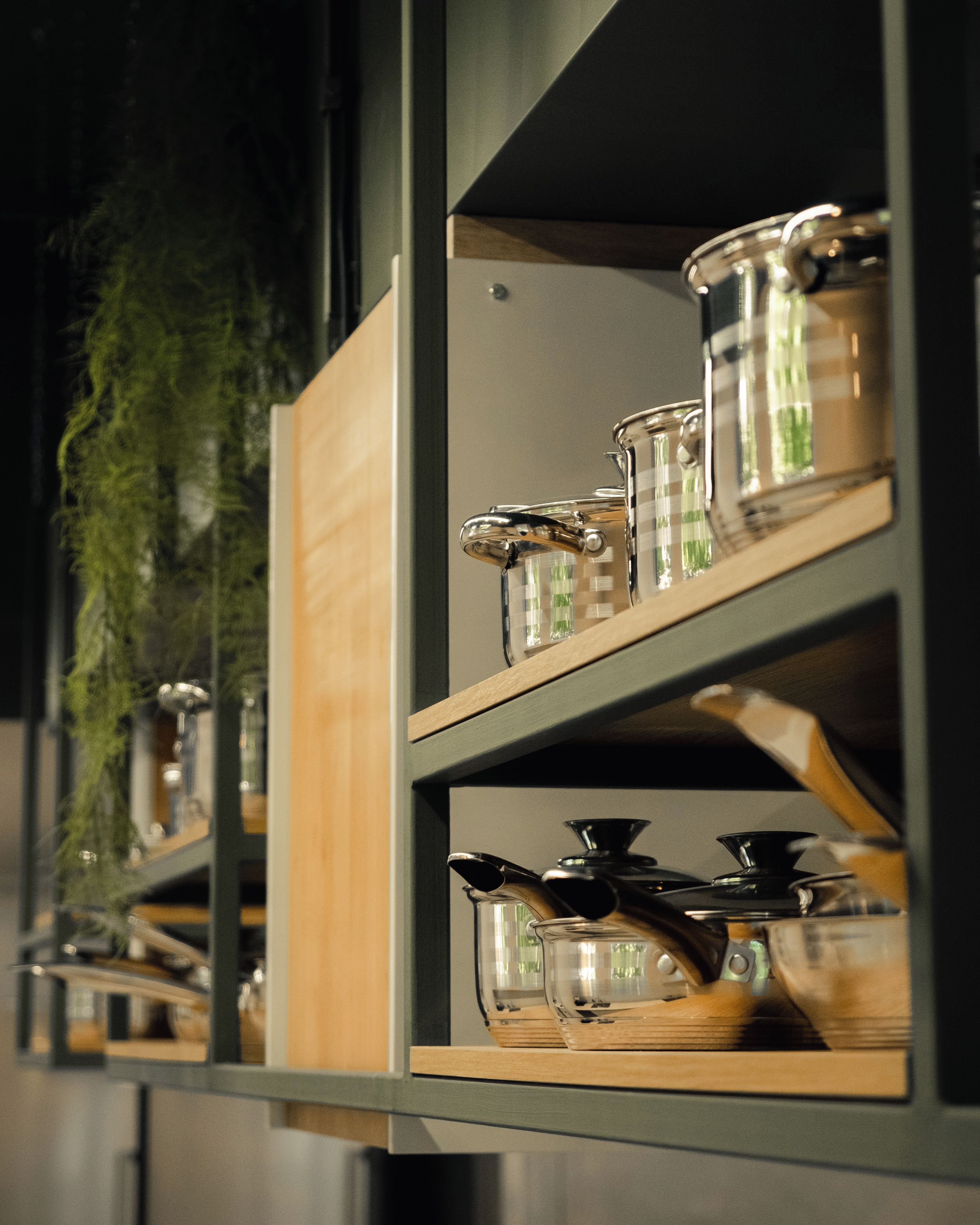 A kitchen with open shelves displaying various kitchenware.