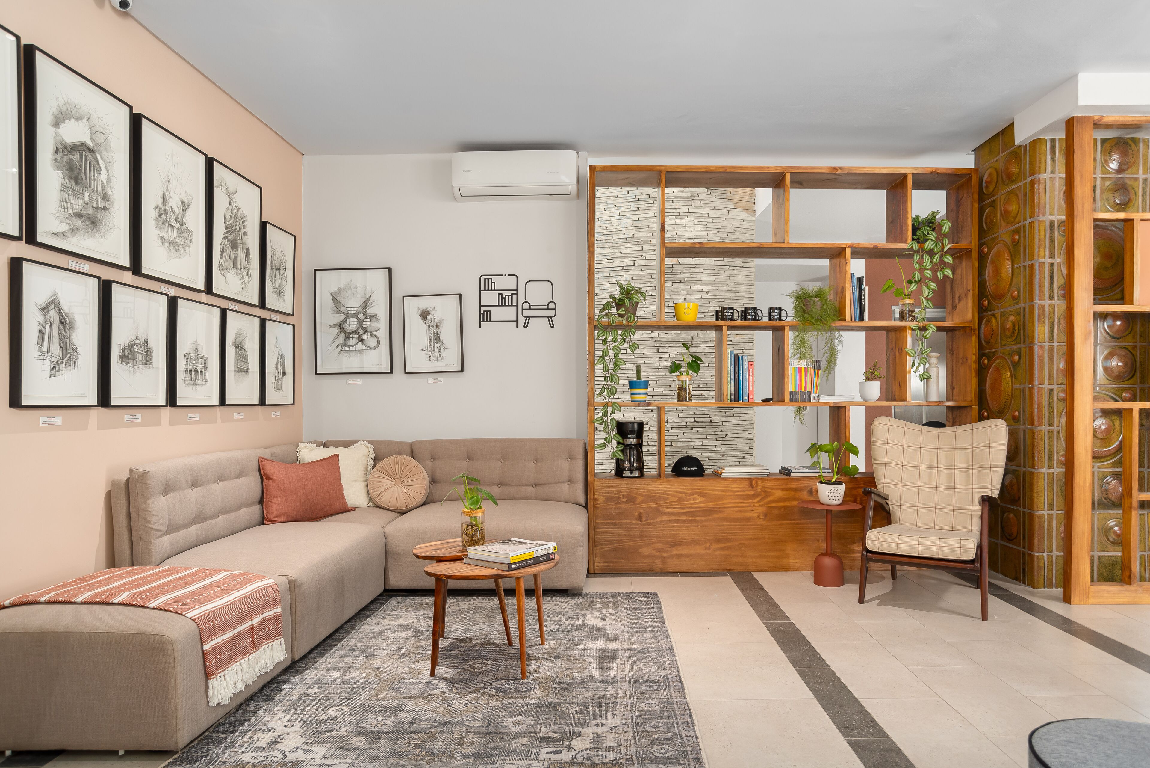 A modern living room with a sofa, coffee table, and a bookshelf.