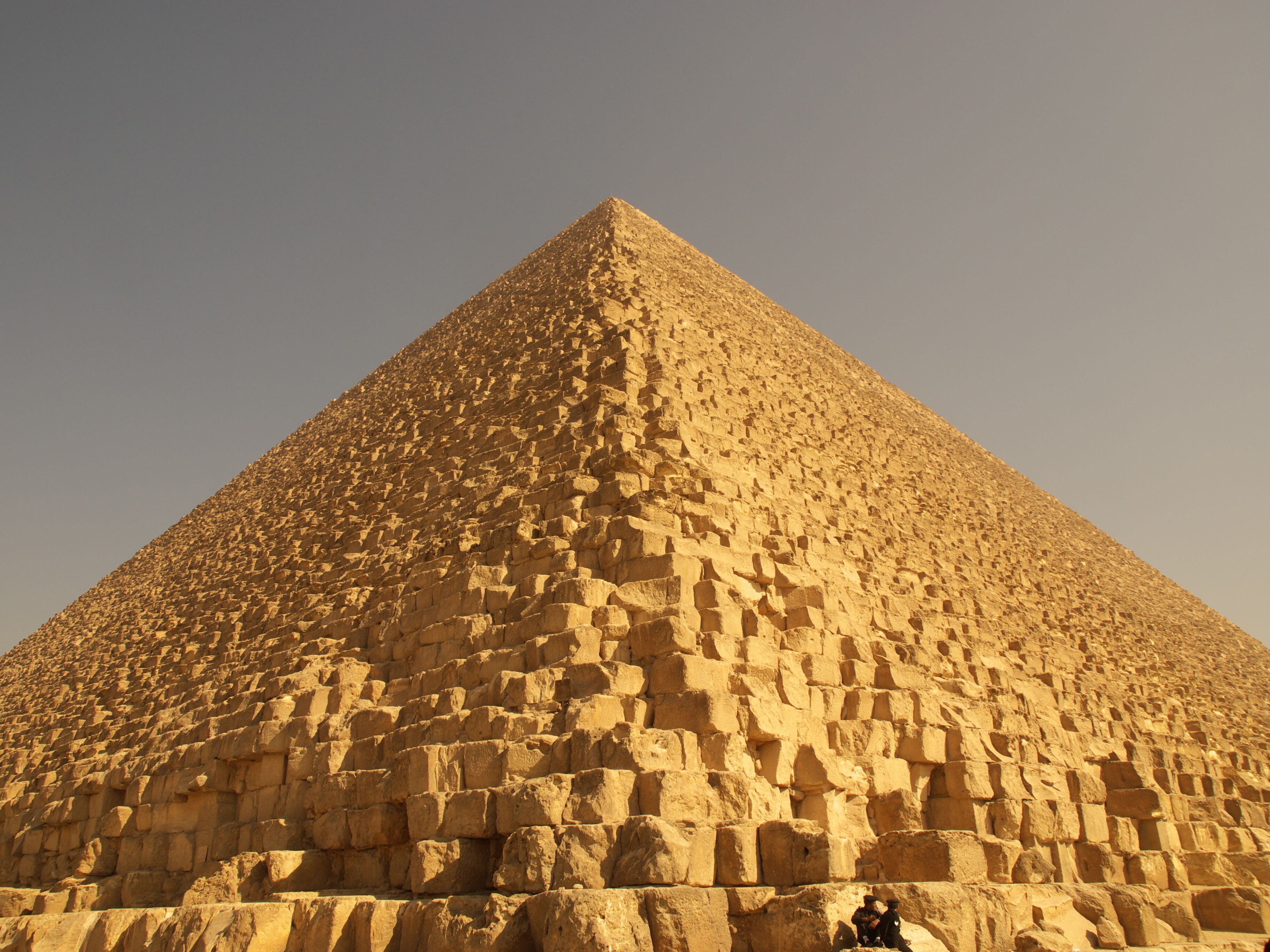 A large pyramid structure with a clear sky in the background.
