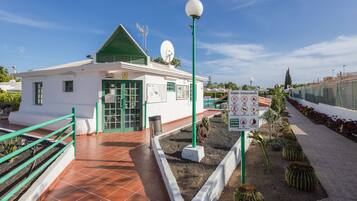 Guests can access this public facility through the green-framed entrance with a glass door.