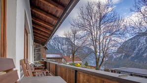 A wooden balcony with a view of snow-capped mountains and bare trees. - Ferienwohnung Plattner by Interhome (Ötz)
