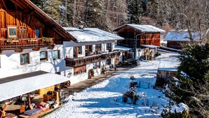 A snow-covered mountain village with wooden houses, a ski lift, and a clear view of the surrounding forest. - Ferienwohnung Plattner by Interhome (Ötz)