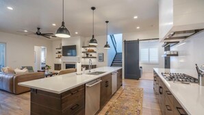 A modern kitchen with a central island, built-in appliances, and pendant lighting. - Arcadia 66 + 67 | TWO POOLS + HOT TUBS + ARCADES + POOL TABLES (Santa Clara)