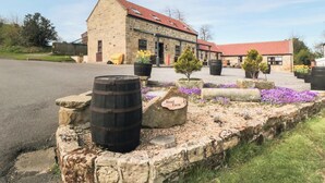 A stone building with a red-tiled roof, a barrel, and a sign labeled "Head Farm." - The Granary - UK43951 (Lingdale, near Saltburn-by-the-Sea)