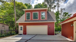 A two-story house with a red exterior, a white garage door, and a covered driveway. - < 1/2 Mi to Old Town: Cozy Bluffton Getaway (Bluffton)