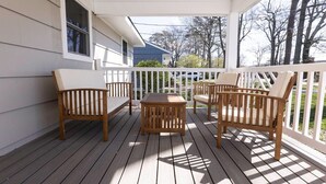 A wooden deck with a white railing, a table, and four chairs. - Beach Vibe with Hot tub! 10 min walk to the Beach! Amazing Backyard! (Virginia Beach)